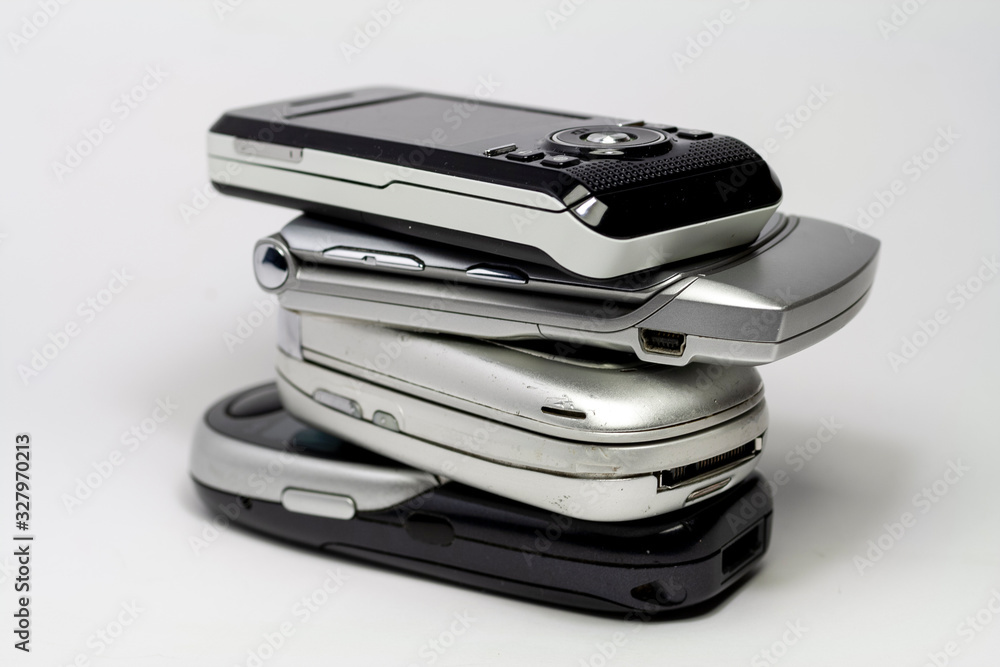 Stacked old mobile phones on white background Stacked old mobile phones on white background