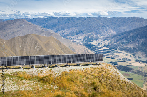 photovoltaic solar panels on the slope above valley in Mount Aspiring National Park, South Island, New Zealand photo