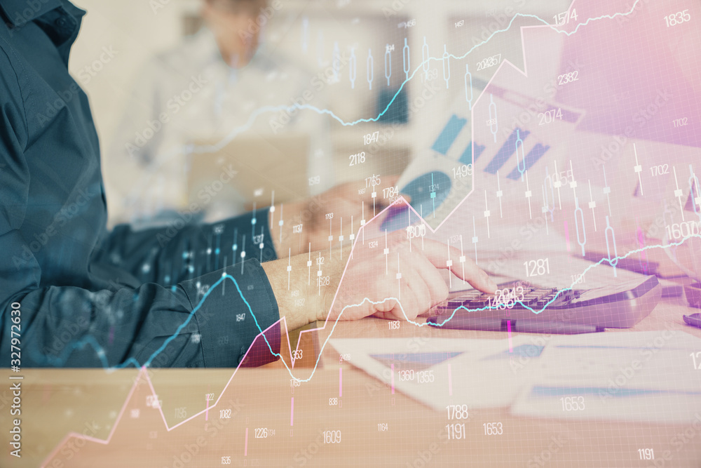 Double exposure of graph with man typing on computer in office on background. Concept of hard work. Closeup. Double exposure of graph with man typing on computer in office on background. Concept of hard work. Closeup.