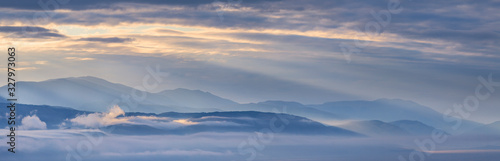 Wallpaper Mural Dawn in a mountain valley, morning fog and clouds, panoramic view Torontodigital.ca