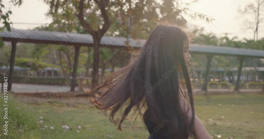 Slow motion: Cute asian Little girl dancing and playing outdoors education school enjoy happiness, teenager fun laughing concept Slow motion: Cute asian Little girl dancing and playing outdoors education school enjoy happiness, teenager fun laughing concept