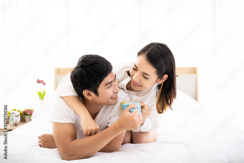 Asian young couple enjoying together with coffee in the morning in badroom, concept of leisure, couple, relationship and valentine. Photograph with copy space. Asian young couple enjoying together with coffee in the morning in badroom, concept of leisure, couple, relationship and valentine. Photograph with copy space.
