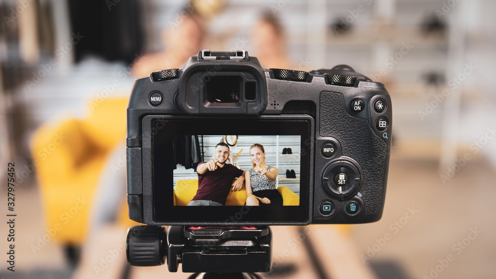 Two caucasian video blogger (Vlog) are live streaming their content and sharing through the internet. Happy couple talking in front of the camera and sharing their video on the social network. Two caucasian video blogger (Vlog) are live streaming their content and sharing through the internet. Happy couple talking in front of the camera and sharing their video on the social network.