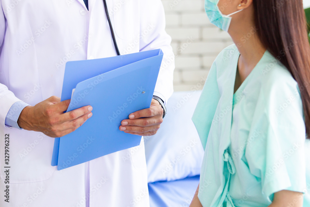 Fototapeta premium Asian woman got a sickness from corona virus and having a consultation with professional doctor in hospital. Doctor explaining about healthcare and sickness avoidance. Medical consultant service.