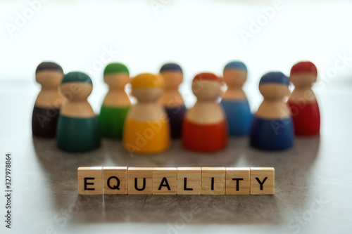 Schilderij op canvas EQUALITY word on wooden blocks with diverse people in the background