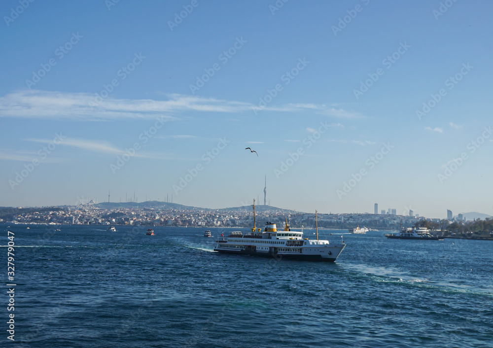 Istanbul / Turkey - December 9 2019: luxury cruise and passenger boat tour in Bosphorus Black Sea in blue sky sunny day in winter