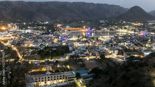 Pushkar,Rajasthan,India,illuminated by town lights at dusk from the hilltop at Gayatri temple.