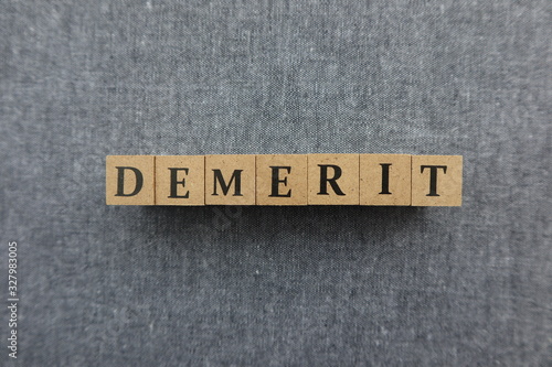 'DEMERIT' word made with wooden blocks