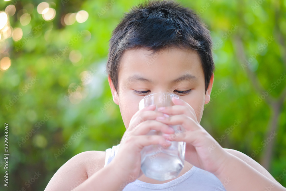 Boy drinking water in the morning Boy drinking water in the morning