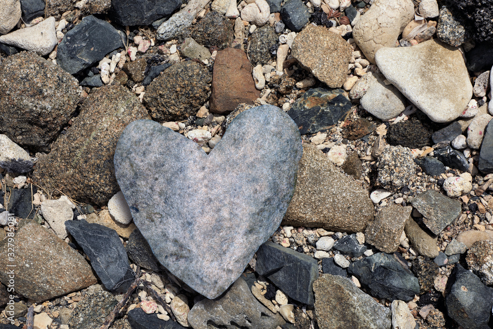 close up heart shaped stone on rocky beach close up heart shaped stone on rocky beach
