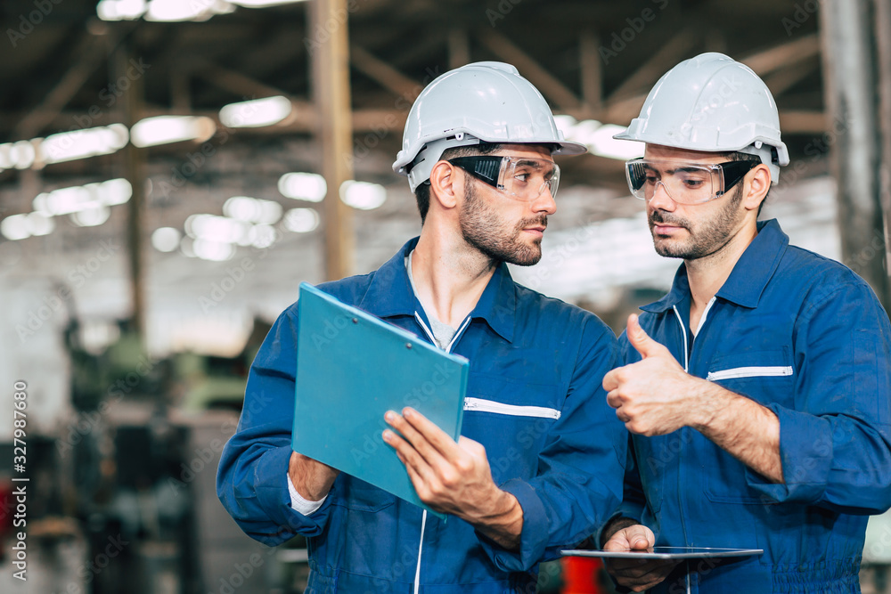 worker working together looking at a boy friend face. Gay men fall in love with friends at work in factory. worker working together looking at a boy friend face. Gay men fall in love with friends at work in factory.