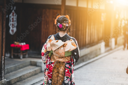  Young women wearing traditional Japanese Kimono with colorful maple trees in autumn is famous in autumn color leaves and cherry blossom in spring, Kyoto, Japan.
