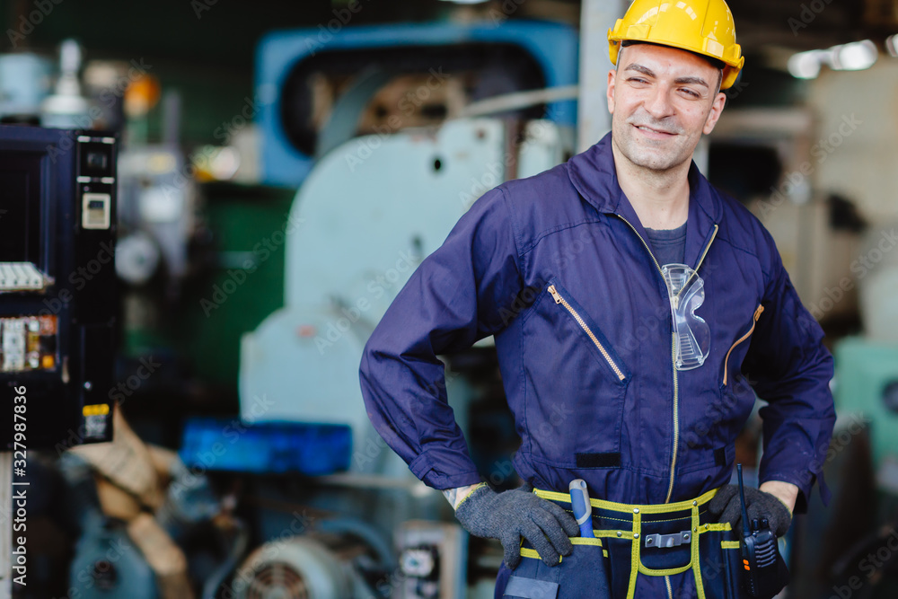 happy worker.engineer smiling for service maintenance fix machine in heavy industy with safty suit and helmet. happy worker.engineer smiling for service maintenance fix machine in heavy industy with safty suit and helmet.