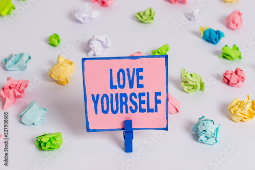 Naklejka Text sign showing Love Yourself. Business photo text have selfrespect and the unconditional selfacceptance Colored crumpled papers empty reminder white floor background clothespin