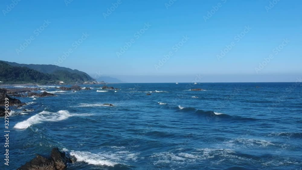 Aerial drone left pan of Yilan Coastline, waves crashing on the beach Aerial drone left pan of Yilan Coastline, waves crashing on the beach