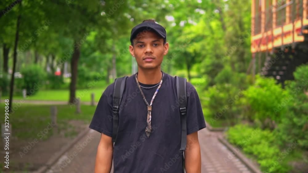 portrait handsome young man with backpack walking on the street slow motion urban city lifestyle summer landscape portrait handsome young man with backpack walking on the street slow motion urban city lifestyle summer landscape
