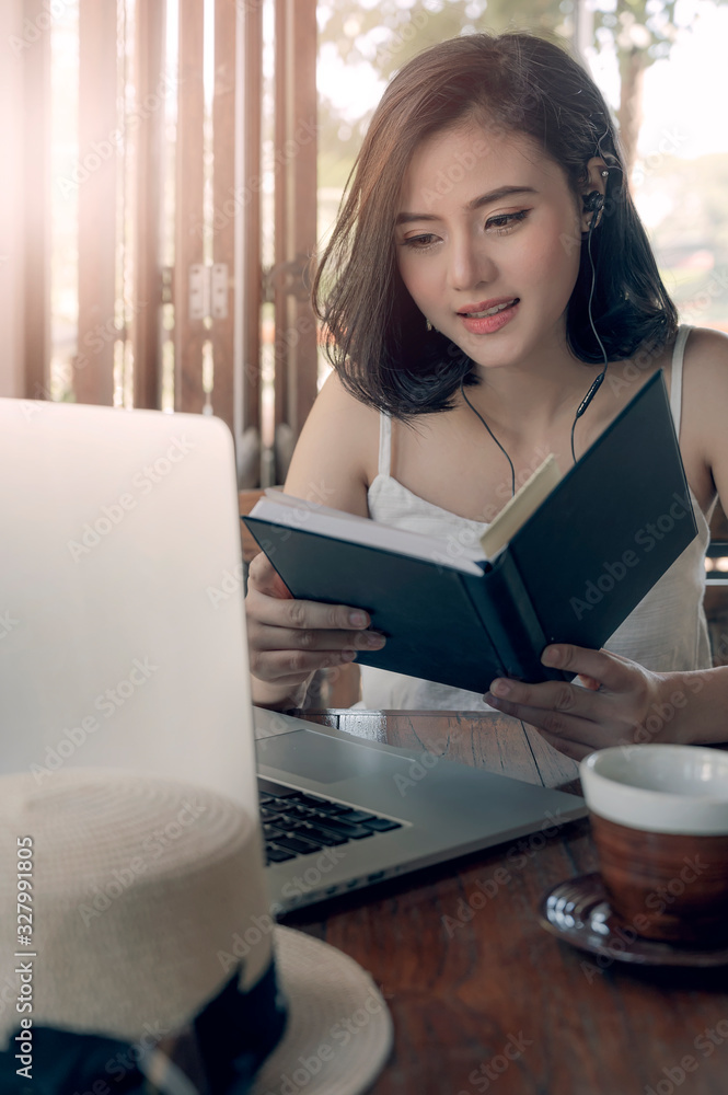 Pretty woman reading book at coffee shop, holiday and summer concept. Pretty woman reading book at coffee shop, holiday and summer concept.