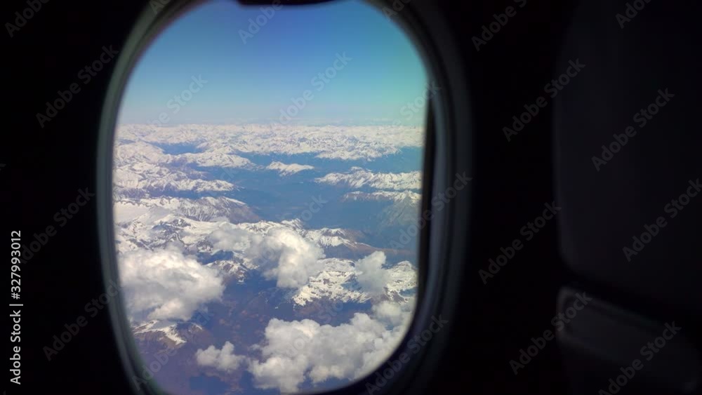 Flying on an airplane. Sunrise or sunset from an airplane illuminator. An airplane wing flies through cotton clouds. The view from the window of the plane. Airplane. Travel by air. Colorful sky Flying on an airplane. Sunrise or sunset from an airplane illuminator. An airplane wing flies through cotton clouds. The view from the window of the plane. Airplane. Travel by air. Colorful sky