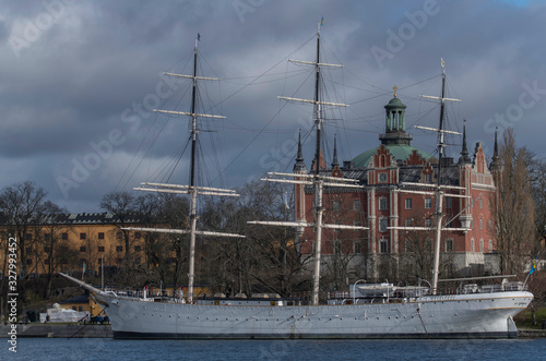 A winter day in Stockholm, view from a pier over the island Skeppsholmen with old sail boat and old houses