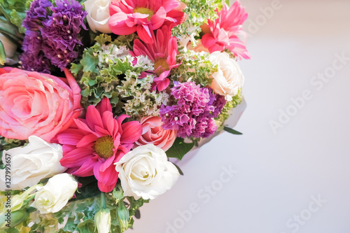 Elegant bouquet of amaryllis  chrysanthemums and roses on a white background. A large bouquet of exotic flowers.Selective focus  blurred flowers.arrangement of fresh flowers.Copy space