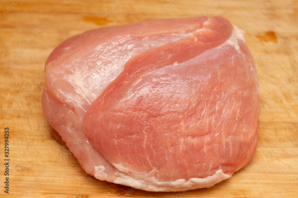 fresh piece of pork ham meat on a cutting board with a knife fresh piece of pork ham meat on a cutting board with a knife