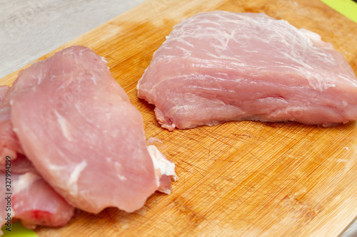 sliced pieces of fresh ham pork meat on a cutting board