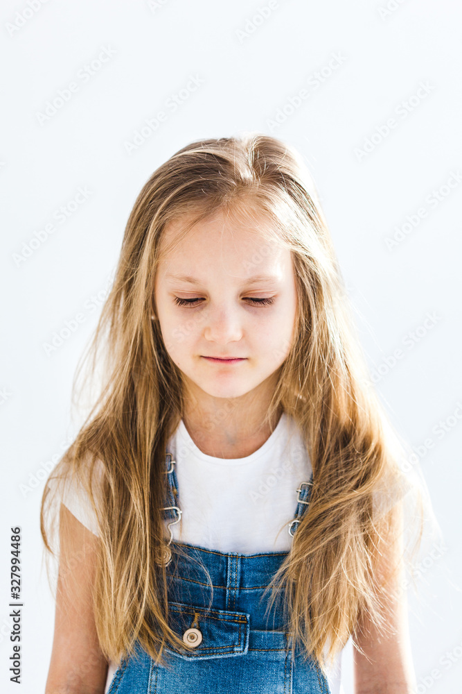 Girl of European appearance with light long hair sadness on her face, thoughtfulness, childhood, school, parents, grades Girl of European appearance with light long hair sadness on her face, thoughtfulness, childhood, school, parents, grades
