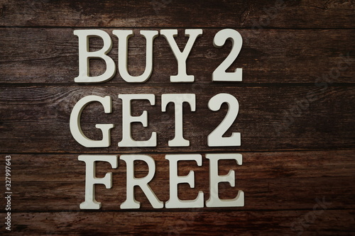 Buy 2 Get 2 Free with space copy on wooden background