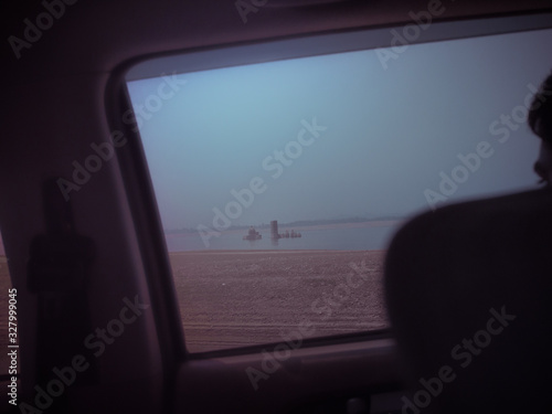 Ancient Temple submerged through a car window (ID: 327999045)