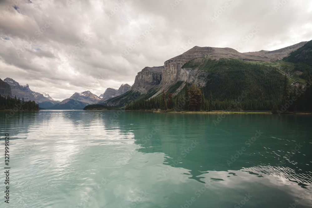 Beautiful Canadian Rockies Landscape with Mountains and Clear Blue Lake Water during Cloudy Summer Weather in Jasper National Park