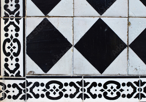 Fragment of a facade decorated with black and white tiles of azu