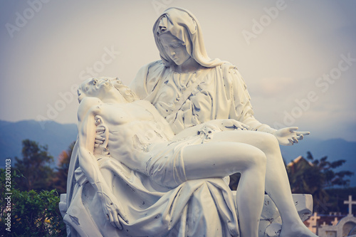 фотографія La Pieta statue - The blessed Virgin Mary holding dead Jesus Christ body