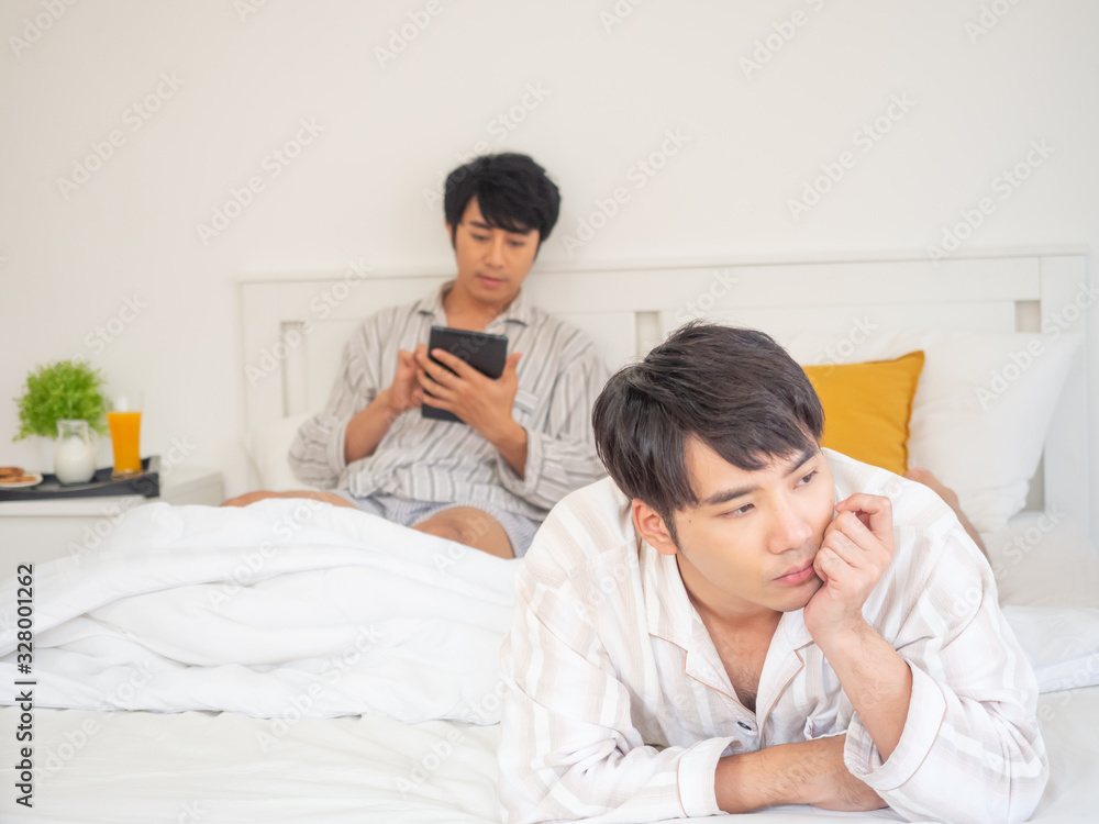 couple gay concept.angry asia man argument with each other play tablet in bedroom couple gay concept.angry asia man argument with each other play tablet in bedroom