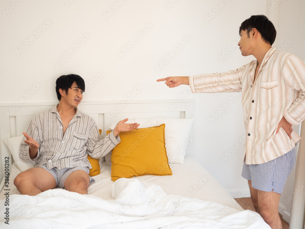 couple gay concept.angry asia man argument with each other play tablet in bedroom couple gay concept.angry asia man argument with each other play tablet in bedroom