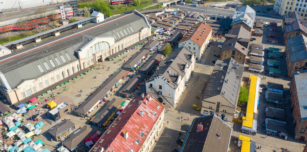 Riga, Latvia – July 18 2019: Aerial view photo from flying drone panoramic on Riga Central market located in the city center next to the Daugava river.