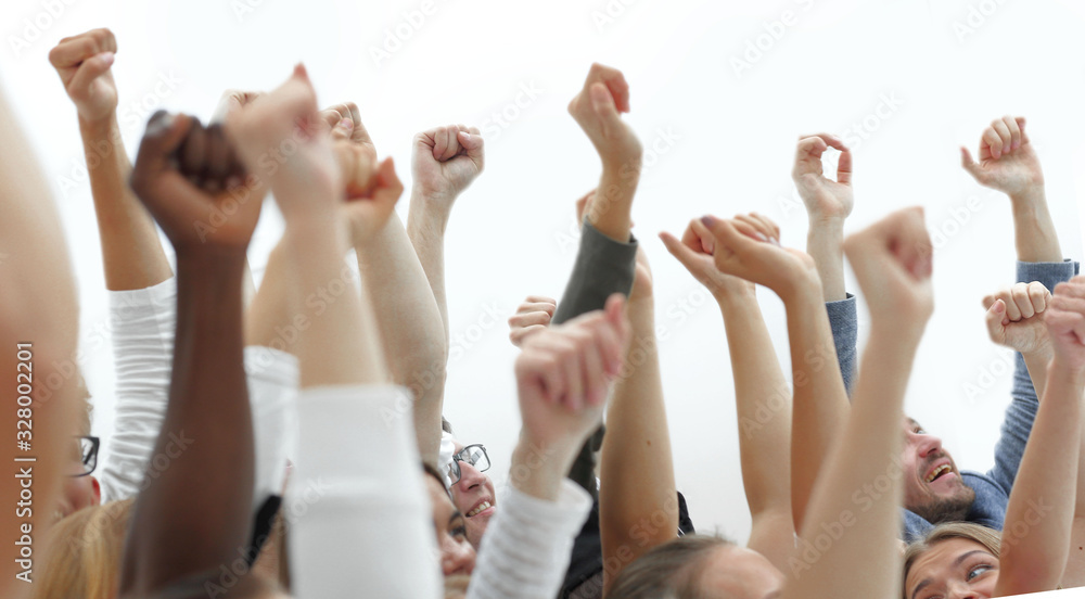 cropped image of a youth group pointing up.