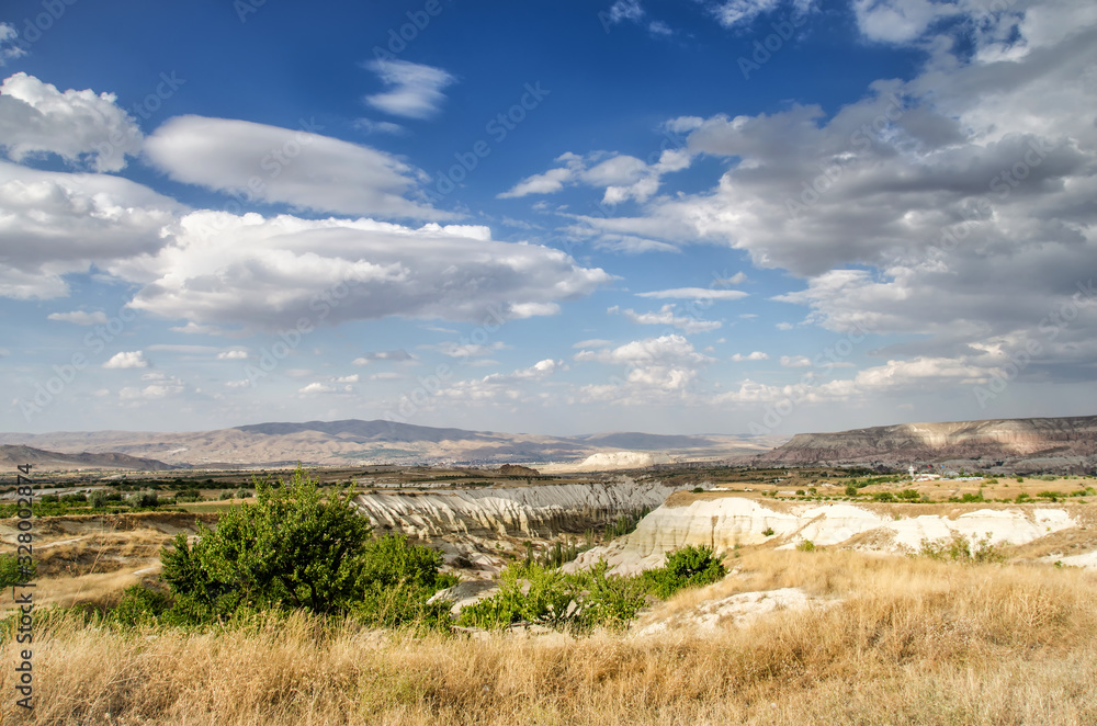 Landscape with a cloudy sky and sandstone formations in Cappadocia, Turkey