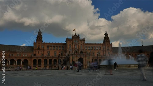 4K Timelapse in Seville 's beautiful Spain Square (Plaza de Espana) with the Vicente Traver fountain, tourists visiting and horse carriages on a cloudy day.