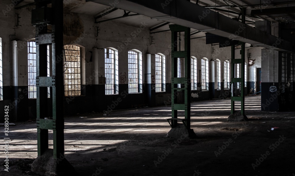 interior of abandoned factory warehouse with large windows