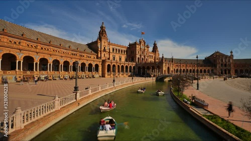 4K Timelapse of the Plaza de Espana (Spain Square) with the canal, wood rowing boats and tourists strolling in Seville City.