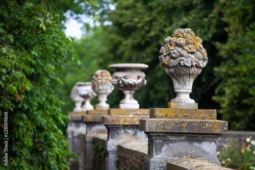 old stone decorative planters on stone wall in european garden