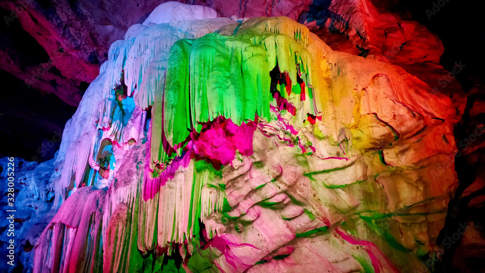 Colorful lights falling on limestone caves