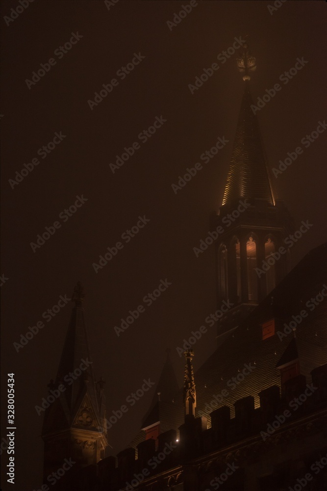 glowing cathedral towers at night with mist