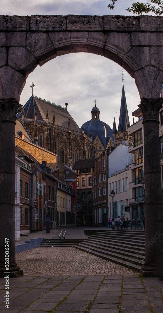 view of cathedral through arch in aachen germany