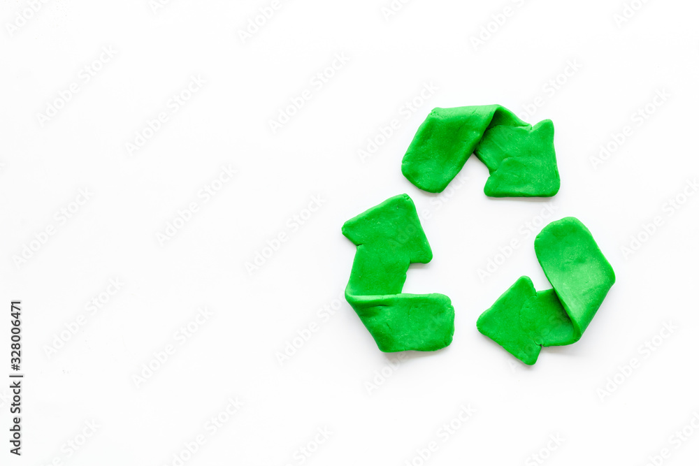 Recycling symbol - green arrows - on white background top-down copy space Recycling symbol - green arrows - on white background top-down copy space