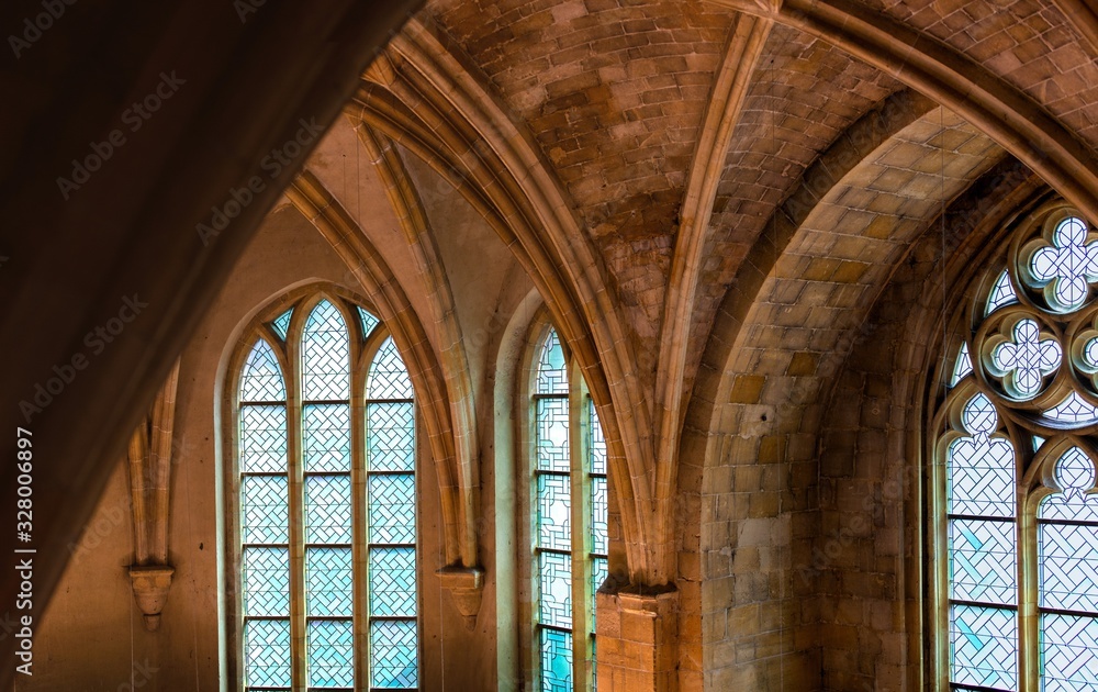 windows inside of catholic cathedral with arches and stained glass