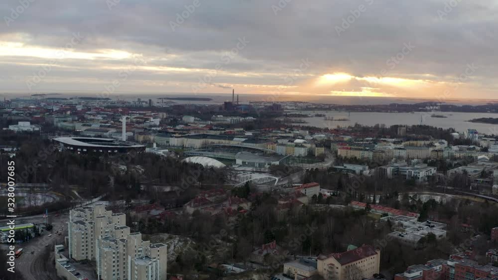 Aerial, drone shot towards Toolo and Ruoholahti area and the sea, cloudy sunset, in Helsinki, Finland
Aerial, drone shot towards Toolo and Ruoholahti area and the sea, cloudy sunset, in Helsinki, Finland