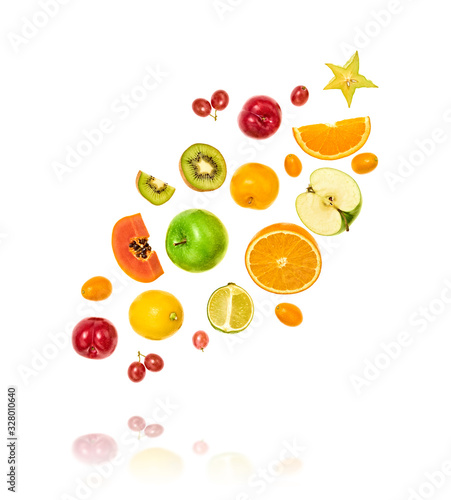 Fresh fruits flying in air. Papaya, apple, orange, kiwi, melon, citrus isolated on white. Fruity vegan tropical mix background. Colorful levitation, falling fly fruit creative concept