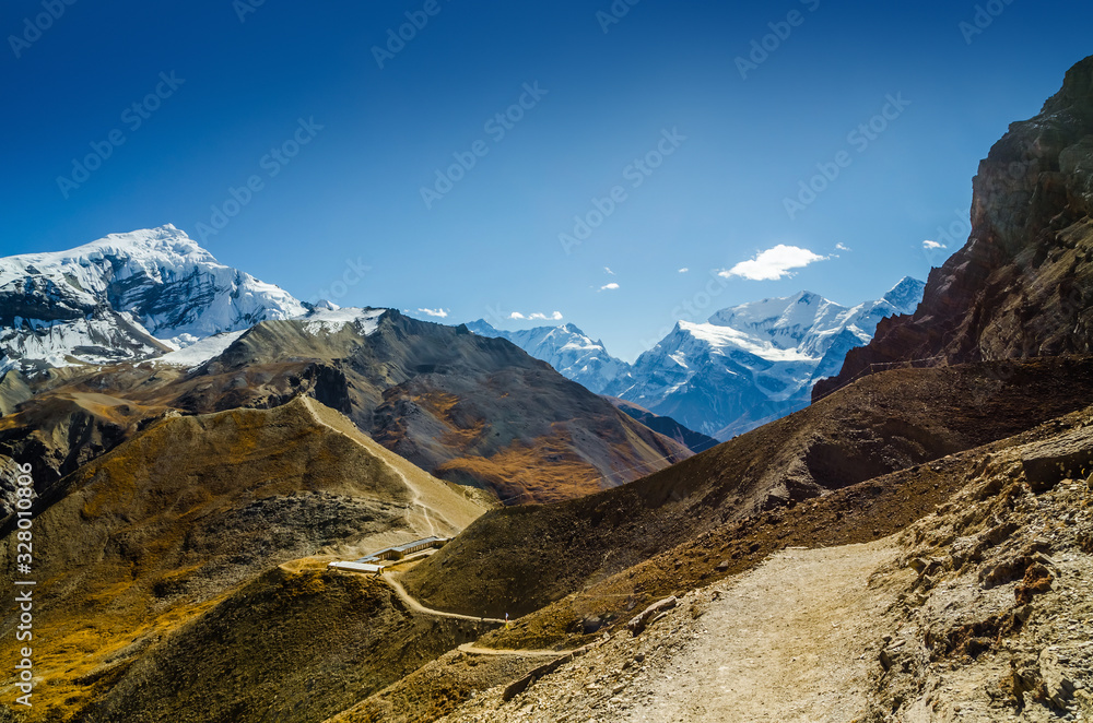 Trekking route to Thorung La pass near Thorund High Camp with Mt. Chulu and Gangapurna on the horizon. Annapurna circuit trek, Nepal.