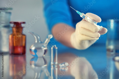 syringe with medicine in hand, for injection, close-up hospital
